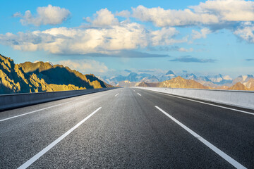 Empty asphalt highway road and majestic mountain natural landscape at a beautiful sunrise © ABCDstock