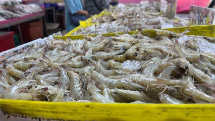 Fresh shrimp on ice at a seafood market stall