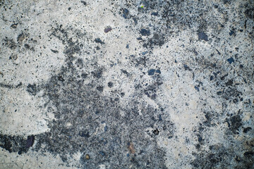 Close-Up View of a Weathered Concrete Surface with Cracked and Textured Patterns