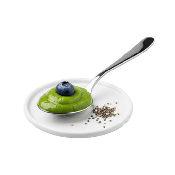 Polished stainless steel tablespoon with verdant green smoothie, plump blueberry, and chia seeds on white plate, isolated on transparent studio, minimalist healthy food concept