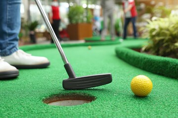 Miniature golf player about to putt