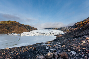 Frozen Glacier Lagoon With Icebergs And Snow Covered Mountains In Iceland. Arctic wilderness landscape, volcanic terrain, glacial lake, winter scenery