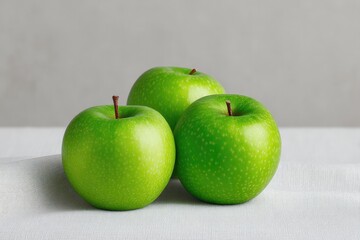 Fresh green apples arranged on neutral background, showcasing vi