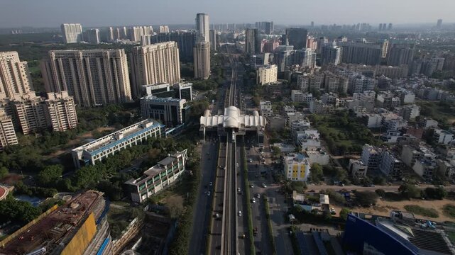 Aerial Drone Footage of Gurgaon Gurugram Buildings skyline Rapid Metro Road Cars traffic in gurgaon city Haryana Delhi NCR