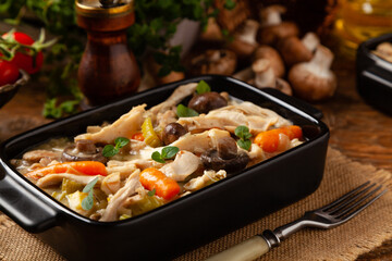 Chicken casserole. Served in black pots.