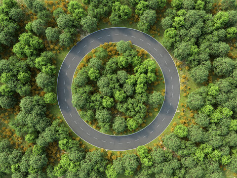 Aerial view of circular road in green forest symbolizing environmental protection
