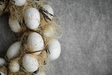 Easter wreath of eggs on a gray background.