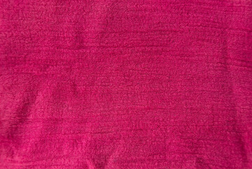 Textured pink red fabric as a dynamic graphic element for a vibrant background