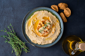 A traditional dish or appetizer hummus or baba ghanoush on black  background