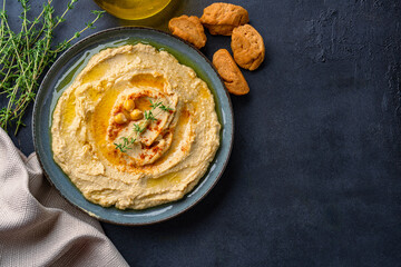 A traditional dish or appetizer hummus or baba ghanoush on black  background