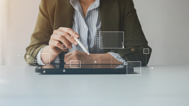 A person using a digital pen interacts with a futuristic interface displayed above a tablet, symbolizing data connection, smart technology, and innovation in digital transformation.