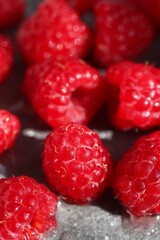 Close-Up of Ripe Raspberries on Textured Gray Background. Summer Flavor and Healthy Eating.