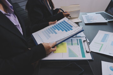 Team of business people working together in the meeting room office,
teamwork background charts and...