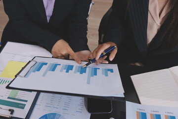 Team of business people working together in the meeting room office,
teamwork background charts and...