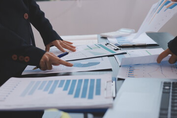 Team of business people working together in the meeting room office,
teamwork background charts and...