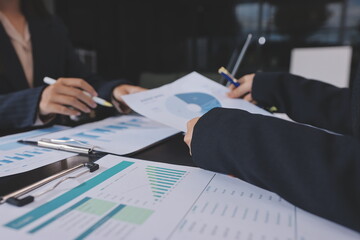 Team of business people working together in the meeting room office,
teamwork background charts and...