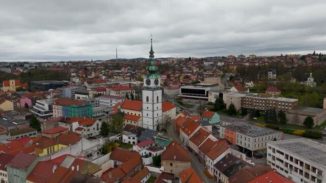 Cinematic aerial drone orbit around the towering Church of St. Martin (Kostel sv. Martina) spire in Trebic, Vysocina, Czech Republic.
