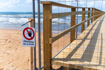 A Beach Pier is currently Under Construction, and Various Water Containers are Present Nearby