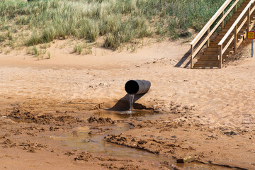 The Pollution Pipe Discharging Waste Water Contaminates the Sandy Beach Area Significantly