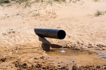 The Pollution Pipe Discharging Waste Water Contaminates the Sandy Beach Area Significantly