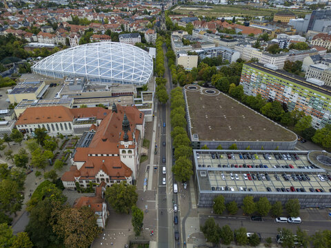 Aerial view of the Leipzig Zoo, where the geometric dome of Gondwanaland meets historic red rooftops, a vibrant contrast against the city's urban tapestry, Leipzig, Saxony, Germany.