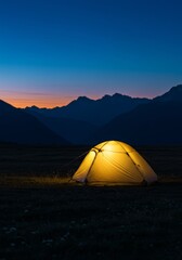 Glowing Tent under a Starry Sky with Mountains at Dusk