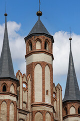 Red brick Gothic Church of the Blessed Virgin Mary with three distinctive spires, Torun, Poland