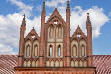 Decorative facade of Gothic 13th century red brick Old Town Hall, Torun, Poland