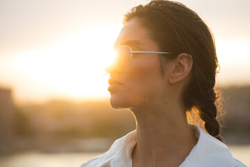 Sensual young woman with amazing smile posing on the street at sunset light