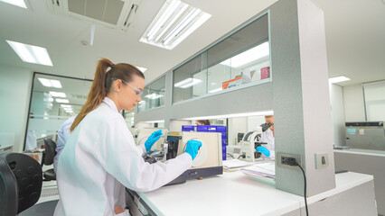 Scientist conducting research in a modern laboratory with advanced equipment during the day