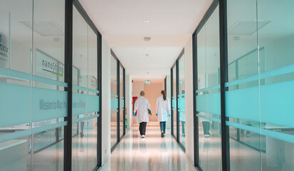 Scientists walk through a modern laboratory corridor during a research session