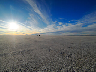 Photography of Salar de Uyuni during dry season, picture taken against the sun low over the horizon