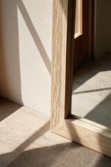 Natural light casting shadows on wooden floor and mirror corner for interior design inspiration