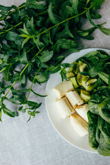 Fresh green smoothie ingredients: spinach, mint, kiwi and banana. Healthy food, recipes, health content	