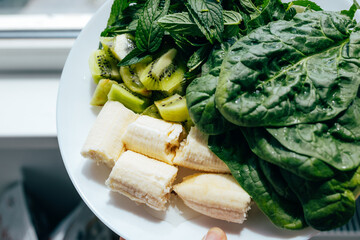 Fresh green smoothie ingredients: spinach, mint, kiwi and banana. Healthy food, recipes, health content	