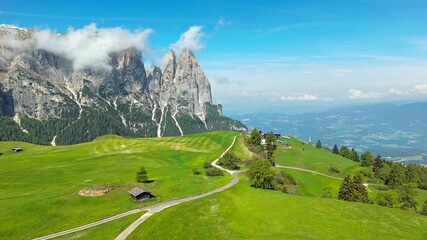 Pasture parcels and huts on Alpe di Siusi facing the Catinaccio group, aerial view. Northern Italy alpine scenery