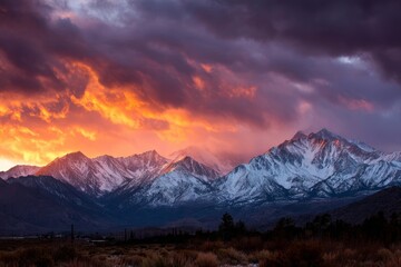 Majestic mountain range under dramatic sky at sunset