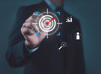 Businessman using digital target interface with arrow hitting center, symbolizing business goal, marketing strategy, customer targeting, success, focus, and precision in achieving objectives growth.