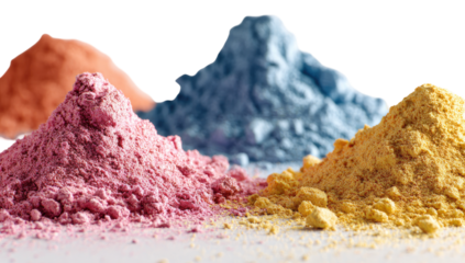 Close-up of three piles of colored powder.  Piles of vibrant pink, light blue, and yellow pigments.  Soft light highlights the texture