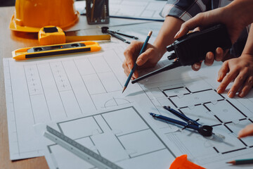 Construction and structure concept of engineer working drawing on blueprint meeting for project...