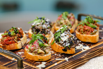 Delicious Assorted Bruschetta on Wooden Board with Fresh Toppings