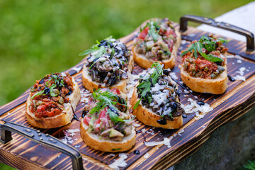 Delicious Assorted Bruschetta on Wooden Board with Fresh Toppings