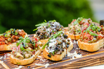 Delicious Assorted Bruschetta on Wooden Board with Fresh Toppings
