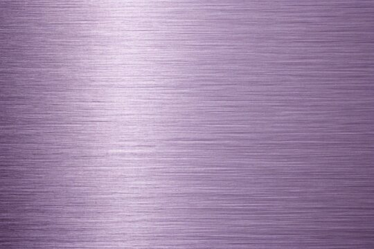 A closeup of a brushed metal surface with a subtle purple hue, showcasing the intricate texture and linear patterns of the material