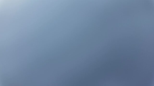Timelapse of a hazy, pale, light gray-blue sky with fog and no clouds