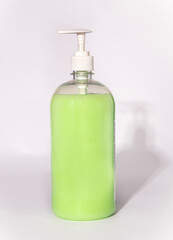 bottle of soap with dispenser on white background
