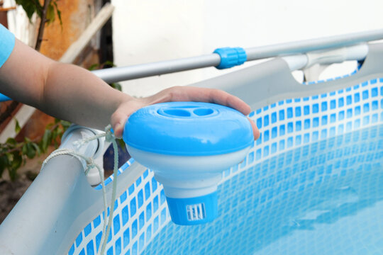 Worker hands isinfection and chlorination of water in the pool. Purification from pollution pool chlor dispenser