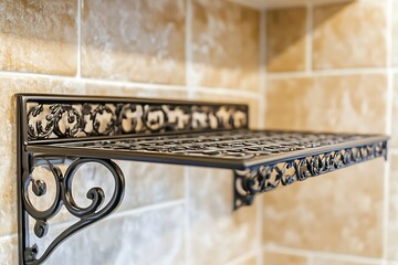Ornate metal shelf, dark color, mounted on beige tiled wall. Decorative design
