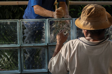 Focus to hand and finger of construction worker who a mason man working on site. Labors building...