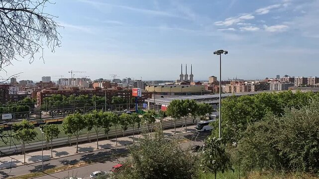 Badalona, Spain-23 August 2024. Panoramic view of the energy towers in Badalona, Spain, from a nature park. The harmony between nature and industry captured from a park overlooking three chimneys.